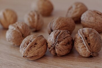 Different walnuts on a wooden table