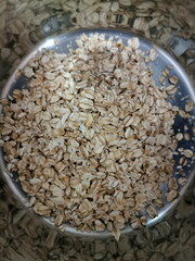Porridge from an aluminum bowl, reflected in the walls of the bowl.