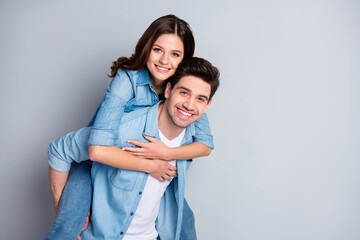 Fototapeta premium Portrait of positive passionate student spouses enjoy togetherness weekend hug piggyback wear jeans casual style outfit isolated over gray color background