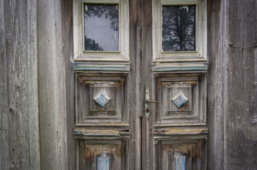 Old gray threadbare wooden door. East Europe