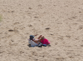 Woman sunbathing on a beach in Brittany