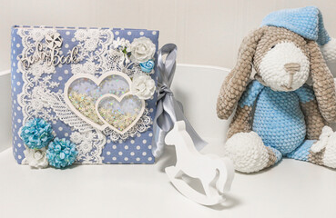 Beautiful soft toy handmade crocheted dog with scrapbooking photo album made for a newborn baby and baby horse. Baby room elements