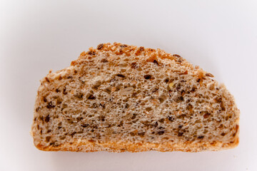 The piece of the French baguette isolated on a white background.