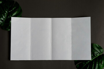 Four-fold brochure mockup above black background