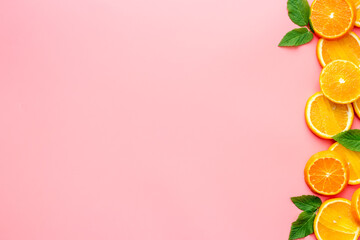 Citrus fruits sliced on pink background top view