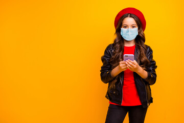 Portrait of her she attractive healthy long-haired girl wearing safety gauze mask using device reading news mers cov copy space isolated bright vivid shine vibrant yellow color background