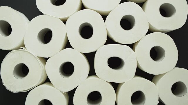 Rolls of toilet paper placed on black background