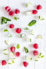 Berries frozen in ice cubes background flat lay