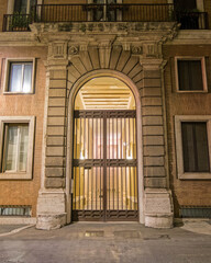 Rome Italy, vintage building entrance arched door, night view