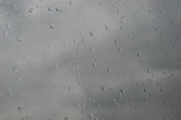 rain drops on the window and grey sky