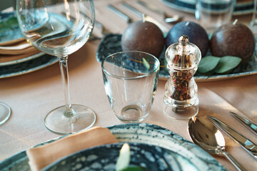 Beautiful elegant table setting with green stylish dishware and silver cutlery