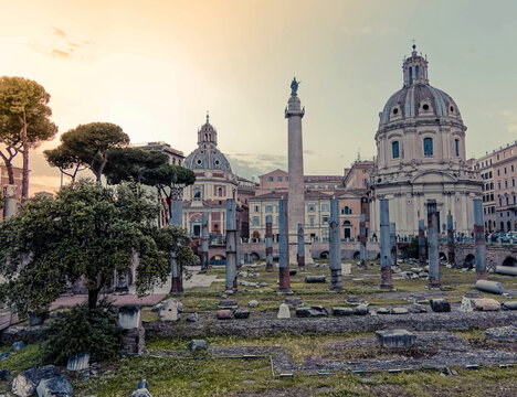 golden hour in Caesar's and Trajan's forum ruins with St.Mary church domes on the babckground, Rome Italy