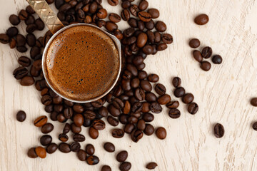 Close up of copper coffee turk on light textured surface