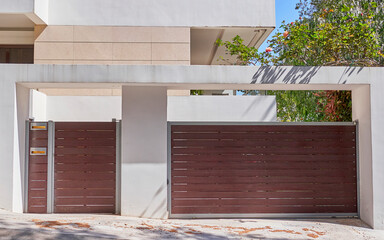 Contemporary apartment building pedestrian and car door by the sidewalk, Athens Greece