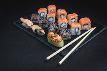Sushi on a black background. Perfect for creating a sushi restaurant menu. Japanese cuisine, Eastern culture.