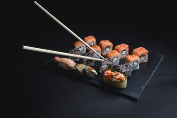 Sushi on a black background. Perfect for creating a sushi restaurant menu. Japanese cuisine, Eastern culture.
