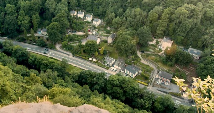 Top-down view of cars traveling on a small road through a village in Derbyshire