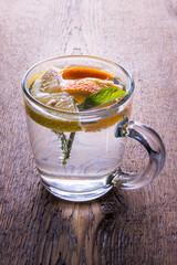 Cup with lemonade and fruits with mint, lemon, orange