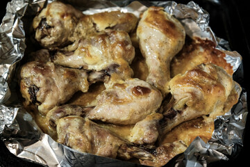 Golden chicken legs in batter fried in a pan