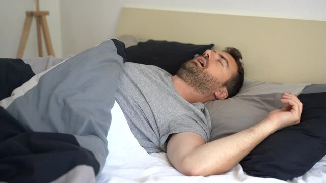 Video about one man snorer in bed breathing with open mouth