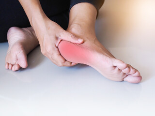 Close-up of foot injury use hand massage on feet to relax muscle from heel pain