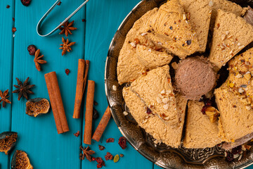 Turkish halva national dessert on blue wooden table