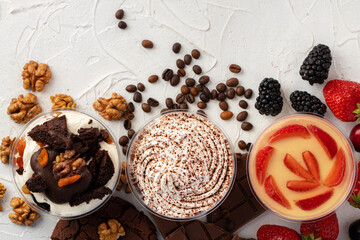 Cocoa mousse dessert in plastic transparent box on grey surface