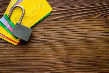 credit card hacked. open lock on wooden table from above space for text