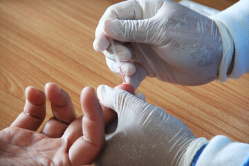 The doctor takes a sample of the patient's blood for a rapid test. Steps to detect a virus or disease.
