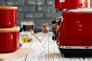 Close up photo of a red toaster on a kitchen table