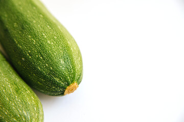 Green zucchini on a white background. The harvest of zucchini.Green vegetables.