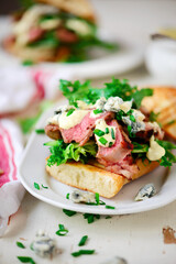 Grilled steak sandwiches with mustard sauce.