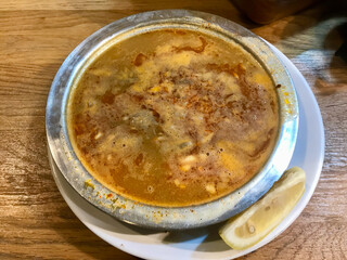 Turkish Soup Beyran with Lamb Meat, Rice, Chopped Garlic and Vinegar Sauce in Local Restaurant.