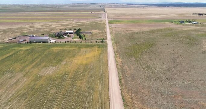 A split shot of a flight down a dusty road in the plains of eastern Colorado.