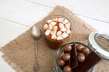 Fototapeta na wymiar Chocolate shake with marshmallows on white wooden table