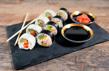 Sushi roll set on the black plate. Japanese food.
