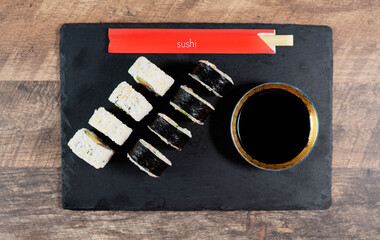 Sushi roll set on the black plate. Japanese food. Top view.