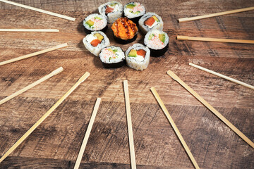 Sushi roll set with chopsticks. Japan sun concept. Place for your text or logo.