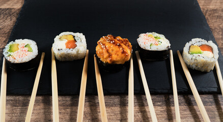 Sushi roll set on the black plate. Japanese food.