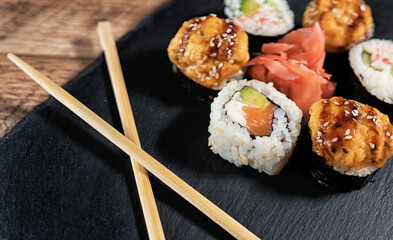 Sushi roll set on the black plate. Japanese food.