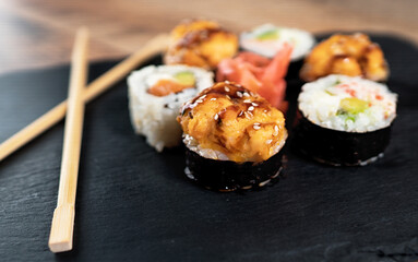 Sushi roll set on the black plate. Japanese food.