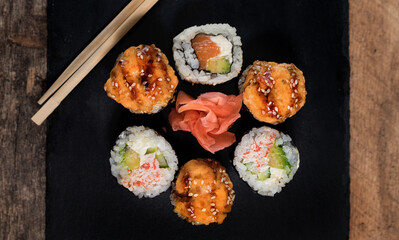 Sushi roll set on the black plate. Japanese food.