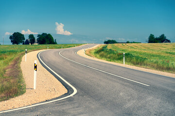 Asphalt road between agricultural fields of Latvia