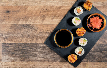 Sushi roll set on the black plate. Japanese food.