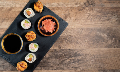 Sushi roll set on the black plate. Japanese food.