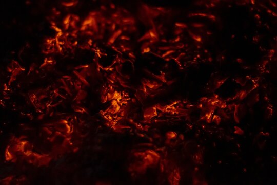Closeup of embers of a burning log creating a fiery background