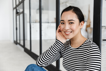 Smiling attractive asian woman wearing casual clothing