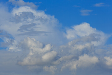 Fototapeta premium White clouds against the blue sky background in sunny cloudy summer day.