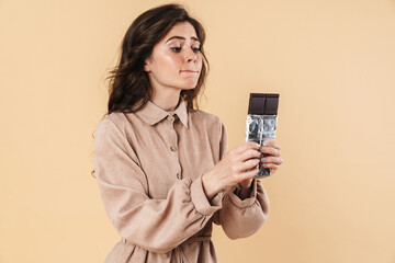 Image of young caucasian woman posing with chocolate on camera