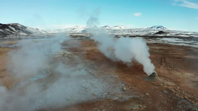 Namafjall Hverir geothermal area in Iceland. Stunning landscape of sulfur valley with smoking fumaroles and blue cloudy sky. Aerial view